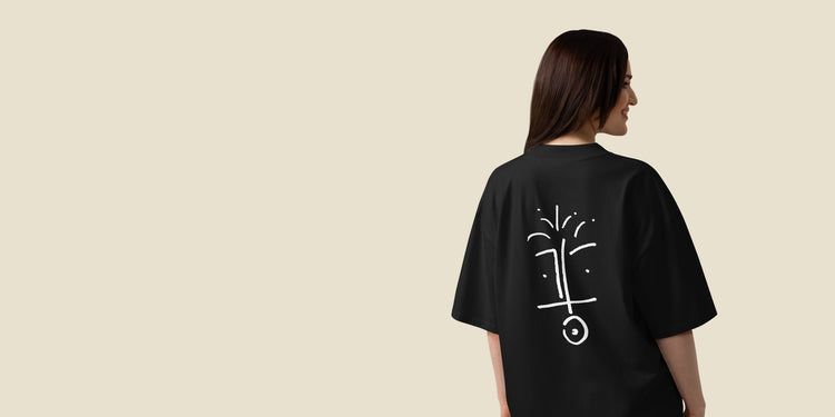 model wearing a black cosmo’s tee, showing the hand-drawn face on the back